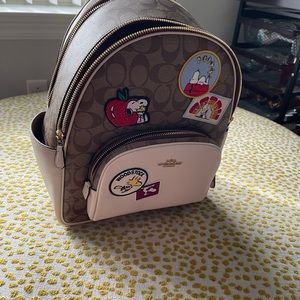 Coach backpack. Peanuts patch work.